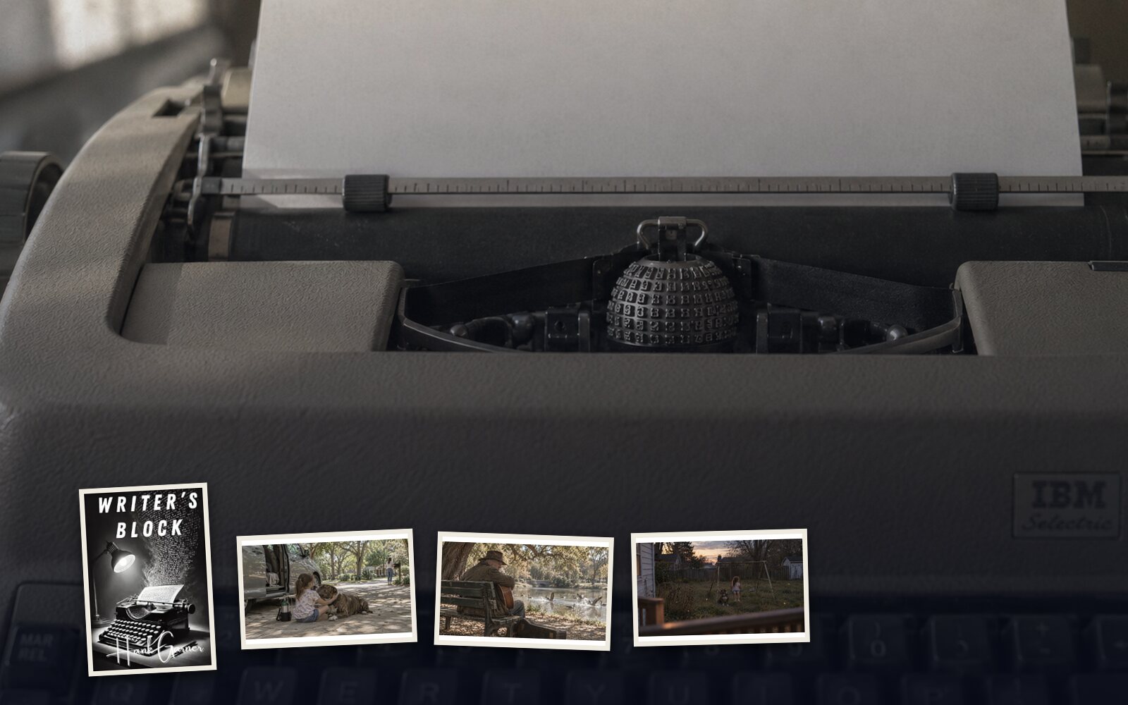 A blank sheet of paper rolled into a 1961 IBM Selectric, with the Writer's Block cover and three scene stills pinned along the bottom